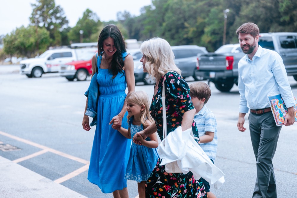 A family walking in together on a Sunday morning